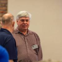 3 people standing and chatting